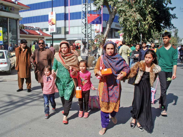 families leave a market after hearing rumours of another blast in gulberg on thursday photo abid nawaz express families leave a market after hearing rumours of another blast in gulberg on thursday photo abid nawaz express