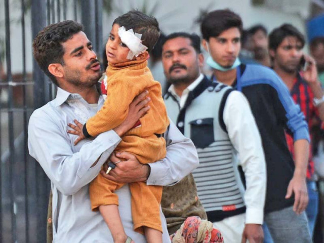 a man at lahore general hospital comforts an injured child photo online a man at lahore general hospital comforts an injured child photo online