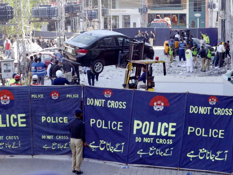 police officials cordon off the blast site in lahore s defence neighbourhood photo afp