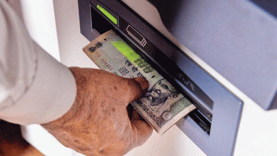cash handler held over toy notes in india atm