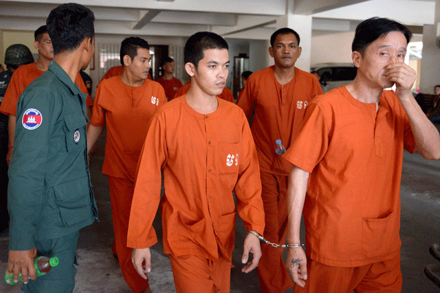 ven sopheap c is escorted by a prison guard l at the phnom penh municipal court on february 24 2017 a cambodian court on february 24 sentenced the 27 year old to two years in jail for facebook posts that threatened strongman prime minister hun sen photo afp