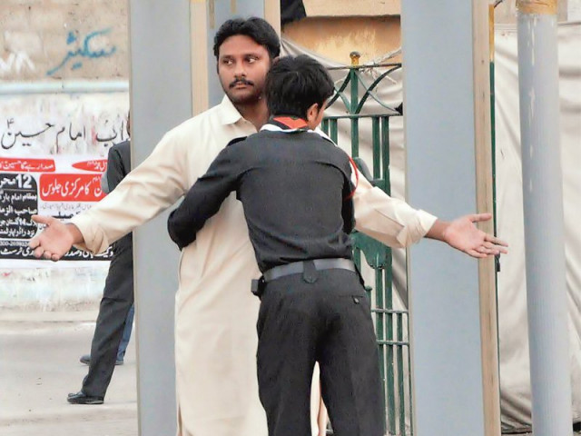 a volunteer frisks a man outside the shah e khurasan imambargah on monday security outside imambargahs has been increased with walkthrough gates installed at a considerable distance from the mosques photo express a volunteer frisks a man outside the shah e khurasan imambargah on monday security outside imambargahs has been increased with walkthrough gates installed at a considerable distance from the mosques photo express