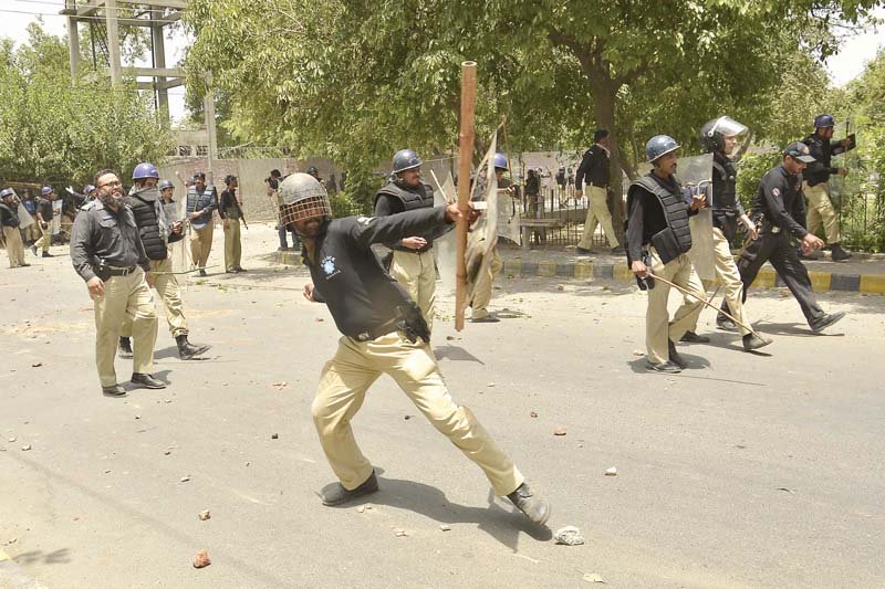 a file photo of policemen responding to qadri supporters in model town photo shafiq malik