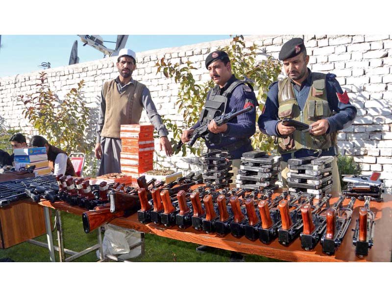 police display seized weapons and ammunitions at the chamkani police station in peshawar photo inp