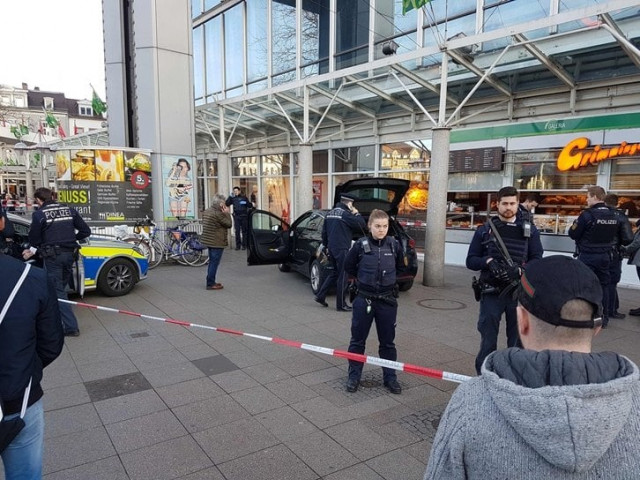 german policemen stand around a car in front of a business building in heidelberg where a man ploughed into pedestrians photo afp german policemen stand around a car in front of a business building in heidelberg where a man ploughed into pedestrians photo afp