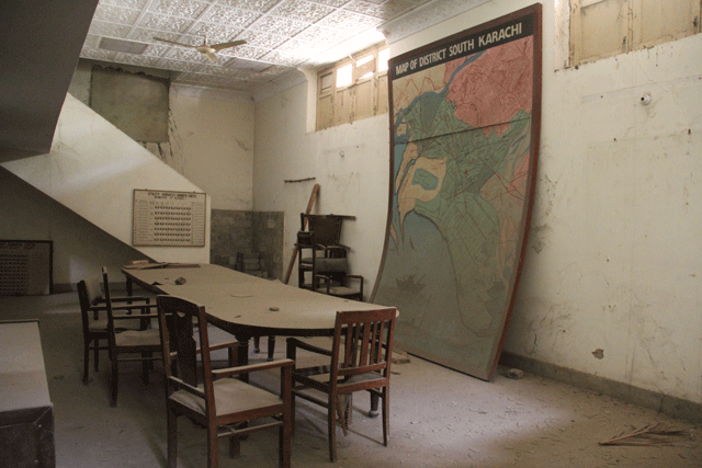 a huge table in the middle of the ccrc room is surrounded by wooden chairs all covered in dust it speaks of how once the officials used to coordinate in a stressed environment while threats of attack loomed on the horizon photo ayesha mir