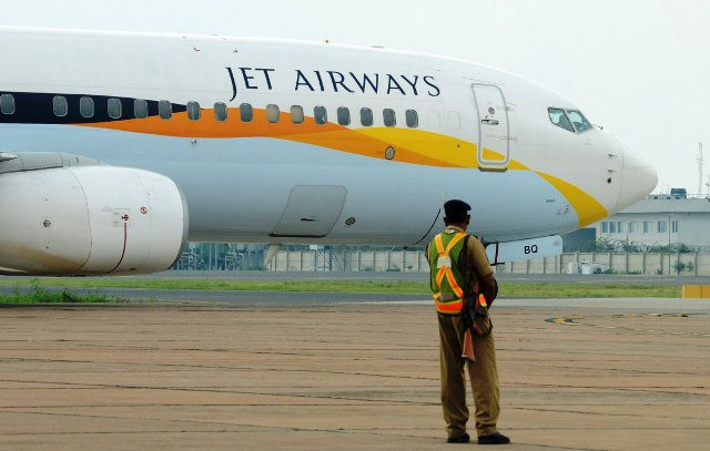 an indian security official looks on as an aircraft of jet airways taxies after landing at indira gandhi international airport in new delhi on september 12 2012 photo afp an indian security official looks on as an aircraft of jet airways taxies after landing at indira gandhi international airport in new delhi on september 12 2012 photo afp