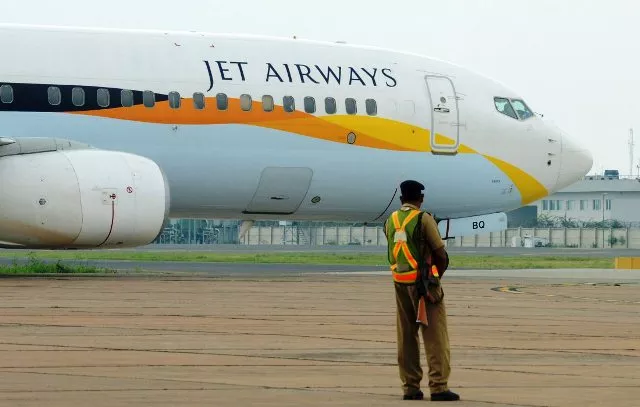 an indian security official looks on as an aircraft of jet airways taxies after landing at indira gandhi international airport in new delhi on september 12 2012 photo afp an indian security official looks on as an aircraft of jet airways taxies after landing at indira gandhi international airport in new delhi on september 12 2012 photo afp
