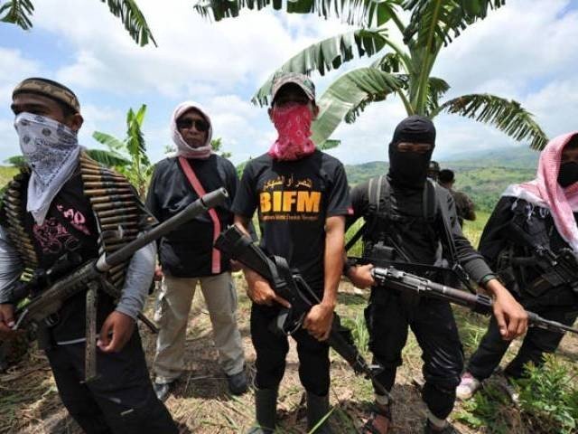 this file photo shows members of a breakaway muslim separatist group stand guard during a clandestine press conference in the town of datu unsay sothern maguindanao province in the philippines on august 28 2011 photo afp