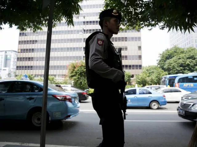 an indonesian policeman holds a rifle as he patrols near a bomb blast site at the thamrin business district in jakarta on january 15 2016 photo reuters an indonesian policeman holds a rifle as he patrols near a bomb blast site at the thamrin business district in jakarta on january 15 2016 photo reuters