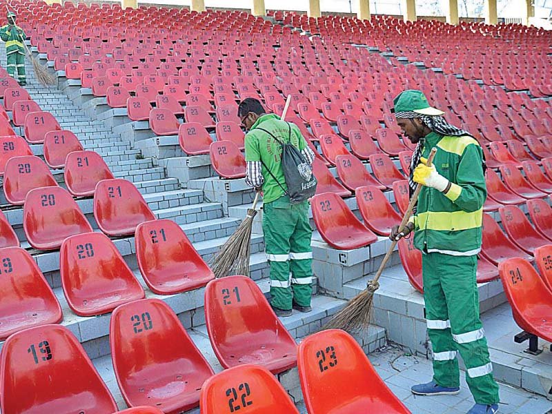 ground staff cleaning the seats as work to prepare gaddafi stadium for its biggest match in years gets under way photo app