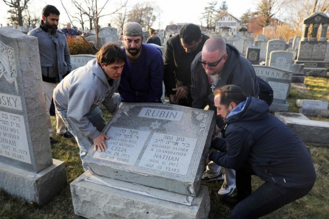 men help lift a fallen tombstone at the jewish mount carmel cemetery on feb 26 in philadelphia police say more than 100 tombstones were vandalized a week after a jewish cemetery in st louis was desecrated photo reuters men help lift a fallen tombstone at the jewish mount carmel cemetery on feb 26 in philadelphia police say more than 100 tombstones were vandalized a week after a jewish cemetery in st louis was desecrated photo reuters