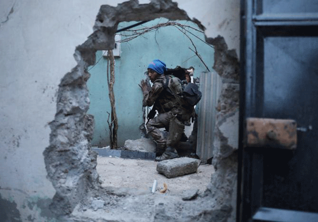 an iraqi special forces soldier moves through a hole as he searches for islamic state fighters in mosul iraq february 27 2017 photo reuters
