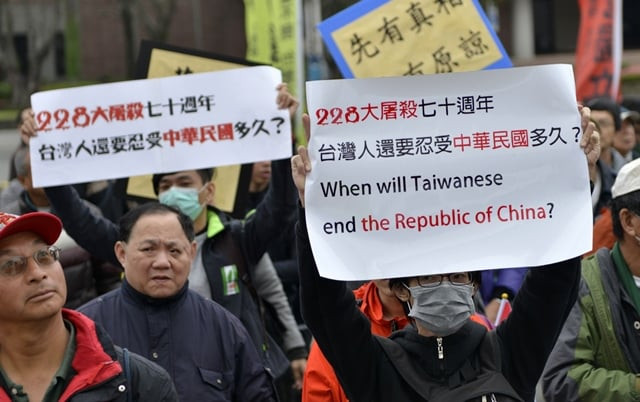 pro taiwan independence activists display signs during the 70th anniversary of the 228 incident in taipei on february 28 2017 photo afp