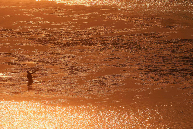 a man fishes in the lempa river in san marcos lempa 84 km from san salvador photo afp