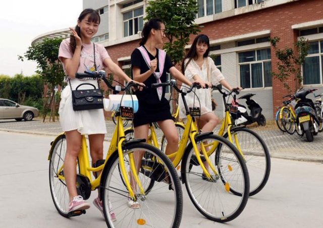 students pose for pictures as they use ofo sharing bicycles at a campus in zhengzhou henan province china september 6 2016 photo reuters