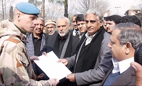 members of the ajk assembly hand over a memorandum of unanimously passed resolutions for the liberation of the people of kashmir to an official of the united nations in muzaffarabad on thursday photo express