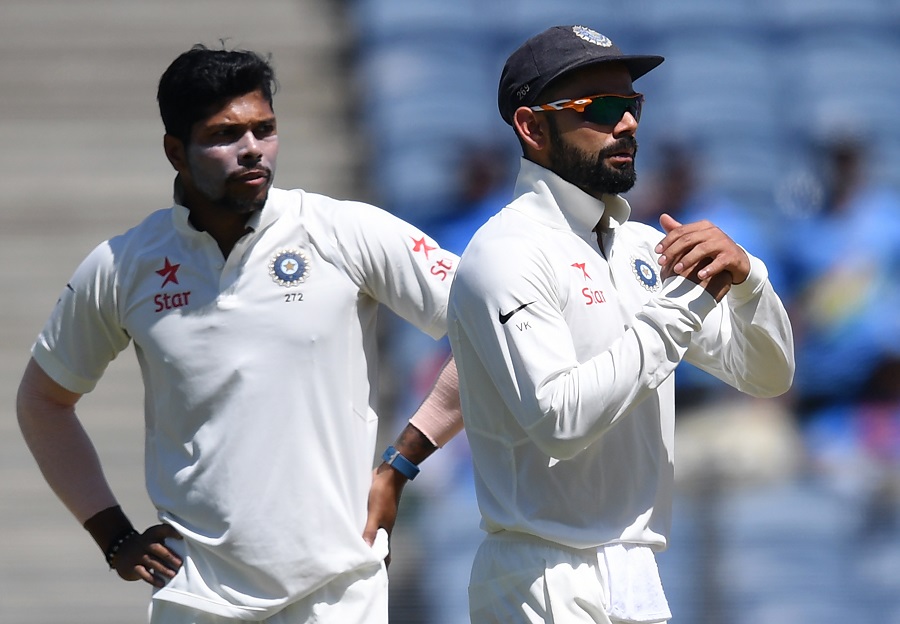 umesh yadav l looks on as captain virat kohli asks for a review of a lbw decision in pune on february 23 2017 photo afp