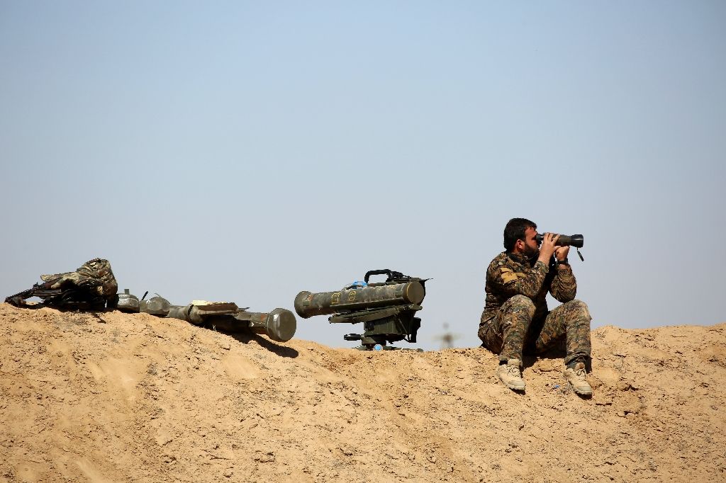 a fighter of the us backed syrian democratic forces sdf made up of an alliance of arab and kurdish fighters looks with binoculars as he sits next to anti tank weapons in the village of sabah al khayr a fighter of the us backed syrian democratic forces sdf made up of an alliance of arab and kurdish fighters looks with binoculars as he sits next to anti tank weapons in the village of sabah al khayr photo afp