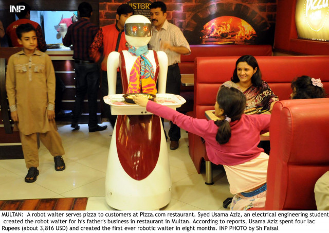 the robot waiter serves pizza to the customers at the outlet in multan photo inp the robot waiter serves pizza to the customers at the outlet in multan photo inp