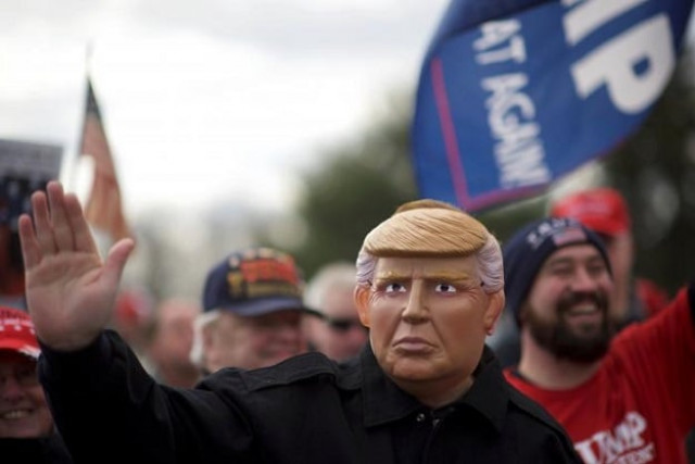 alex carlin waves while wearing a mask depicting president donald trump during a quot people 4 trump quot rally at neshaminy state park in bensalem pennsylvania us march 4 2017 photo reuters alex carlin waves while wearing a mask depicting president donald trump during a quot people 4 trump quot rally at neshaminy state park in bensalem pennsylvania us march 4 2017 photo reuters