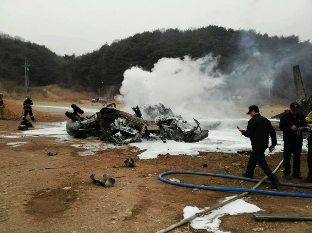 south korean firefighters check the wreckage of a ch 53 us marine helicopter on a training filed in cheorwon on april 16 2013 photo afp yonhap south korean firefighters check the wreckage of a ch 53 us marine helicopter on a training filed in cheorwon on april 16 2013 photo afp yonhap