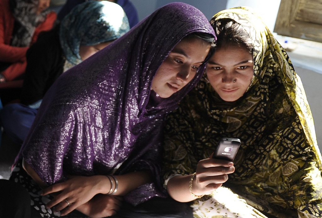 afghan women sit in a class and study using mobile phones in kabul on november 3 2012 photo afp