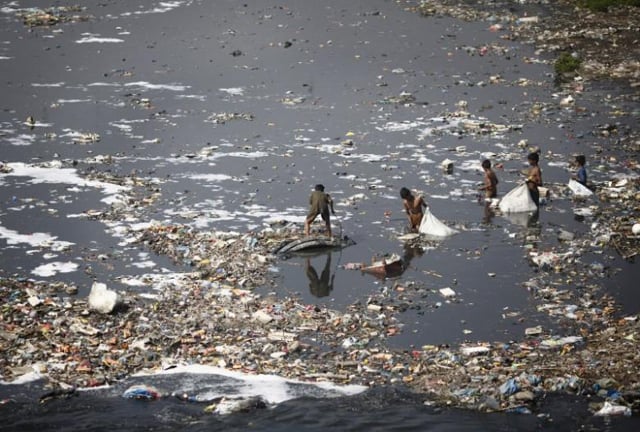 children look for plastic bottles at the polluted bagmati river in kathmandu march 22 2013 photo reuters