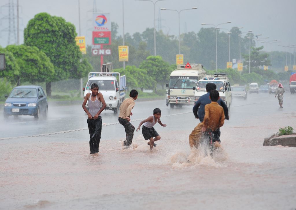 children play in rain in lahore photo afp