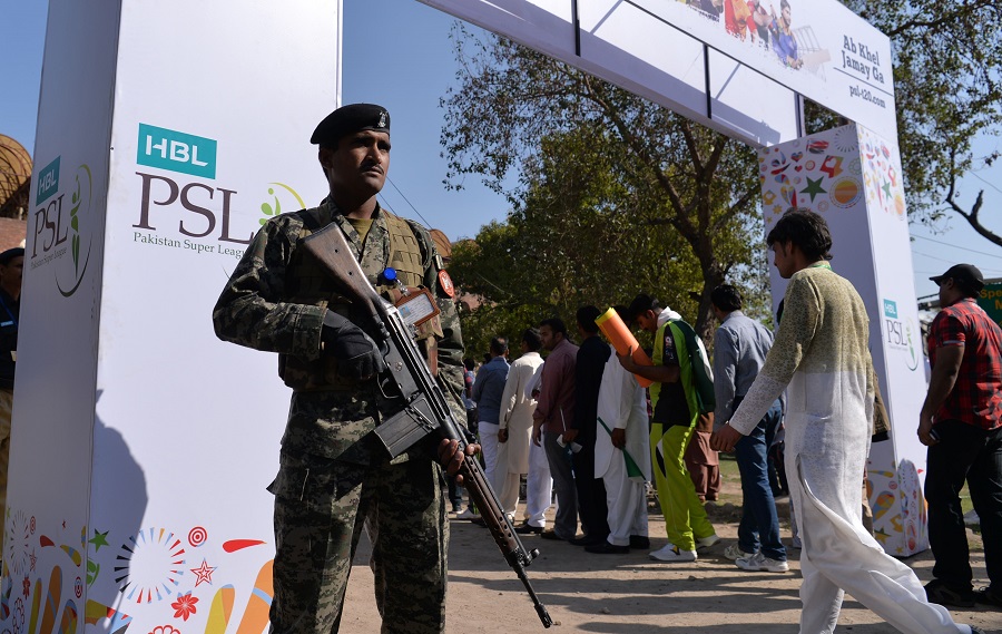 pakistani soldier patrol as spectators queue at an entry gate of the gaddafi cricket stadium in lahore on march 5 2017 photo afp