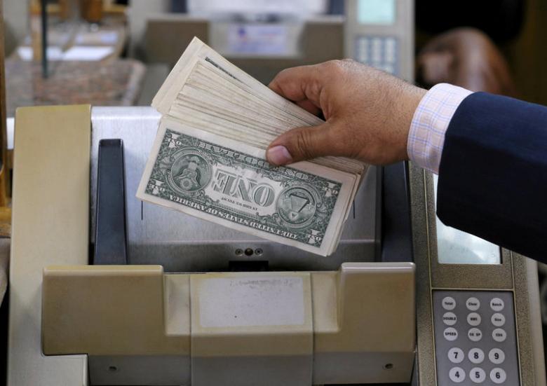 an employee counts u s dollars in a foreign exchange office in central cairo egypt march 7 2017 photo reuters