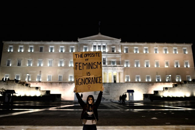 a woman holding a placard stands in front of the parliament building in athens during a demonstration for women 039 s rights on march 8 2017 marking the 40th international women 039 s day photo afp a woman holding a placard stands in front of the parliament building in athens during a demonstration for women 039 s rights on march 8 2017 marking the 40th international women 039 s day photo afp