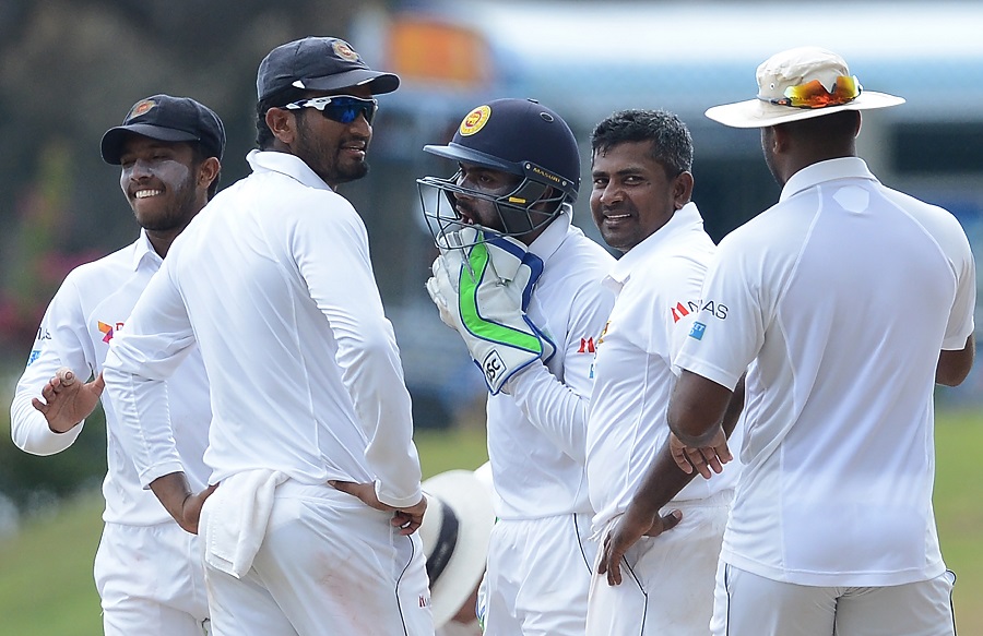 sri lankan spinner rangan herath 2r celebrates with teammates after he dismissed his unseen bangladesh counterpart mushfiqur rahim during the third day of the opening test cricket match between sri lanka and bangladesh at the galle international cricket stadium in galle on march 9 2017 photo afp