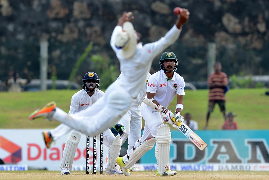 bangladesh cricketer soumya sarkar r watches as sri lankan cricketer dinesh chandimal drops a catch during the fourth day of the opening test match between sri lanka and bangladesh at the galle international cricket stadium in galle on march 10 2017 photo afp