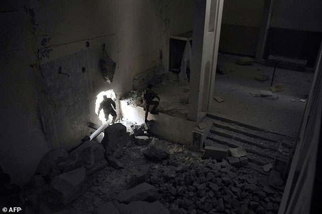 members of the iraqi forces enter the destroyed building of the museum of mosul on march 11 2017 after it was recaptured from islamic state group fighters photo afp