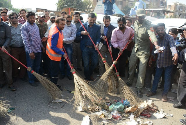mqm pakistan leaders cleaning the city 039 s roads as part of their campaign photo file mqm pakistan leaders cleaning the city 039 s roads as part of their campaign photo file