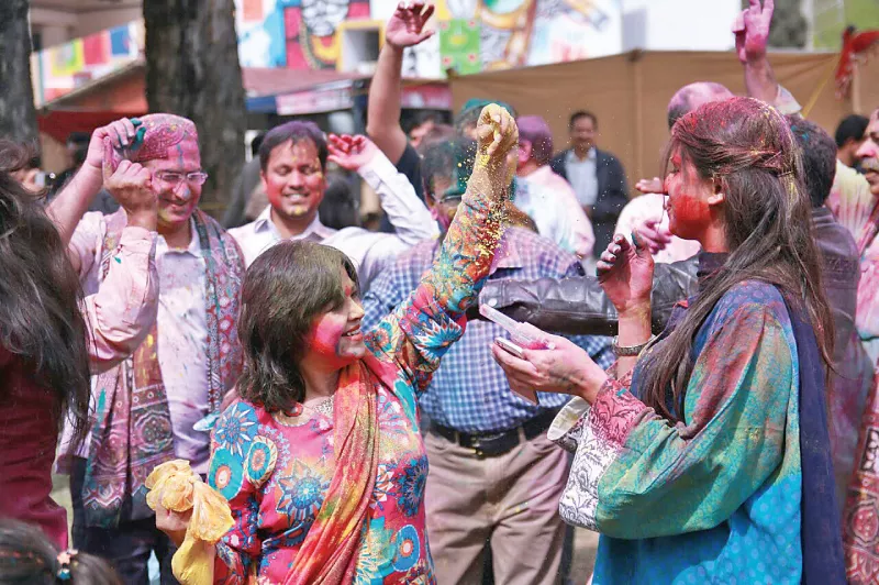 people throw colour at each other at a holi related event in the capital photo express people throw colour at each other at a holi related event in the capital photo express