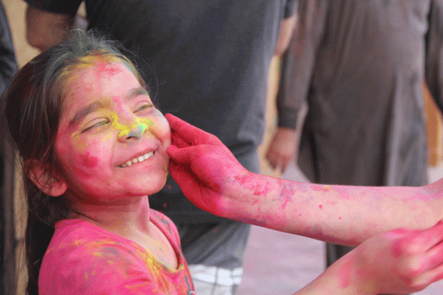 a child smiles as colour is applied to her face during holi at shri lakshmi narayan mandir photo ayesha mir a child smiles as colour is applied to her face during holi at shri lakshmi narayan mandir photo ayesha mir