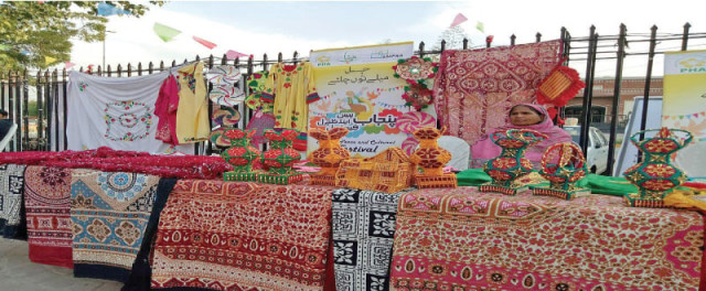 a female vendor sells handmade shawls and decorative items at the event photo express a female vendor sells handmade shawls and decorative items at the event photo express