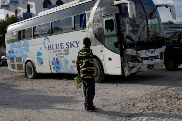 a man looks at a bus which drove into a parade of pedestrians parked in the police station of gonaives haiti march 12 2017 photo reuters a man looks at a bus which drove into a parade of pedestrians parked in the police station of gonaives haiti march 12 2017 photo reuters