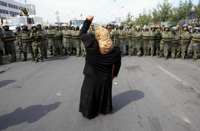 a local woman on a crutch shouts at chinese paramilitary police wearing riot gear as a crowd of angry locals confront security forces on a street in the city of urumqi in china 039 s xinjiang autonomous region photo reuters a local woman on a crutch shouts at chinese paramilitary police wearing riot gear as a crowd of angry locals confront security forces on a street in the city of urumqi in china 039 s xinjiang autonomous region photo reuters