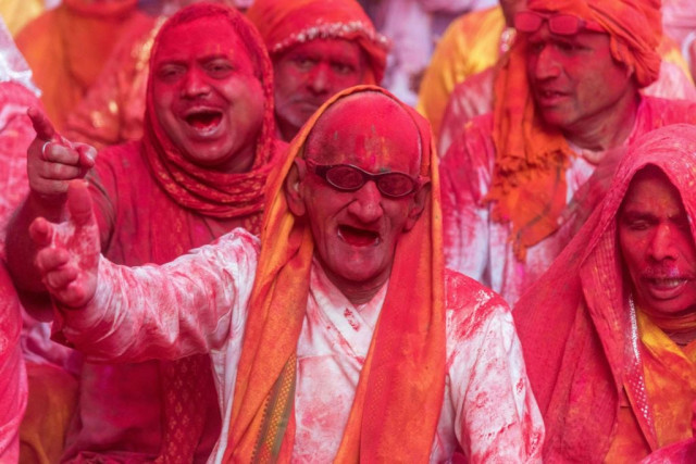 indian villagers are covered in coloured powder during the lathmar holi festival at the radha rani temple in barsana some 130kms from new delhi on march 16 2016 photo afp indian villagers are covered in coloured powder during the lathmar holi festival at the radha rani temple in barsana some 130kms from new delhi on march 16 2016 photo afp