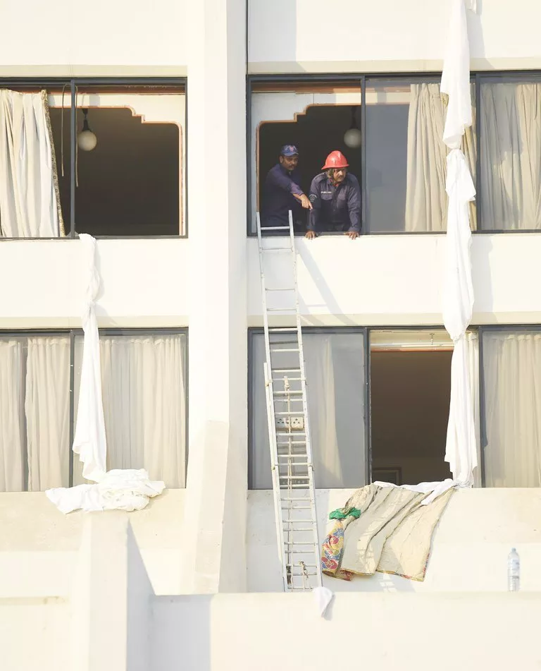 pakistani fire fighters look from a room of regent plaza hotel following a fire in karachi on december 5 2016 photo afp pakistani fire fighters look from a room of regent plaza hotel following a fire in karachi on december 5 2016 photo afp