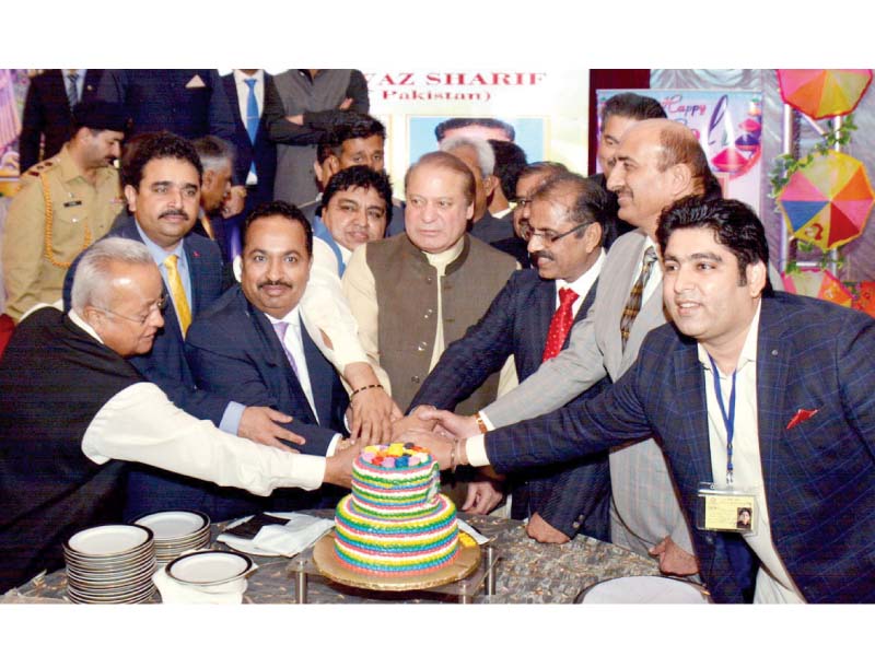 pm nawaz cuts a cake to mark the holi celebrations in karachi photo online