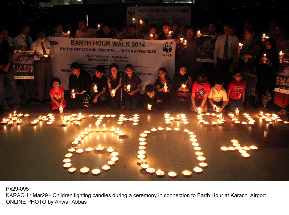 children light up candles as they celebrates earth hour at karachi airport photo online