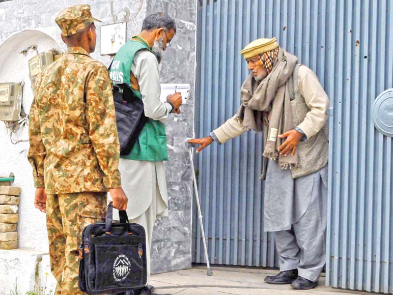 census officials visit a house in rawalpindi while an enumerator fills a form in muzaffarabad photos agencies