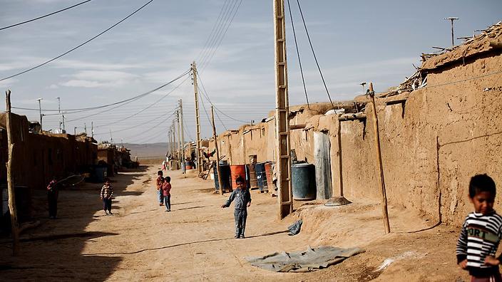 afghan children wander at the shahid nasseri refugee camp in taraz nahid village near the city of saveh near tehran on february 8 2015 photo afp