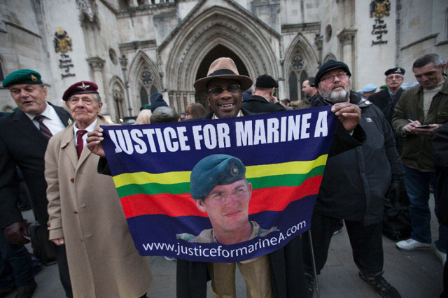 supporters hold a picture of british soldier alexander blackman outside the royal courts of justice in london on february 8 2017 photo afp