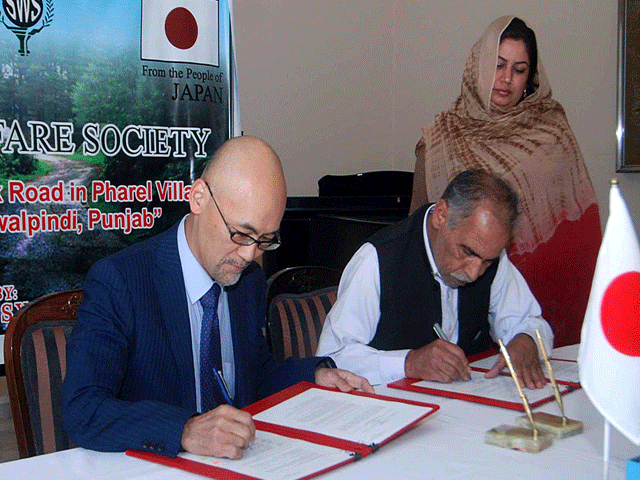 junya matsuura charh d affaires ad interim of embassy of japan in pakistan and representative of sanj welfare society sws signing documents during the ceremony photo app