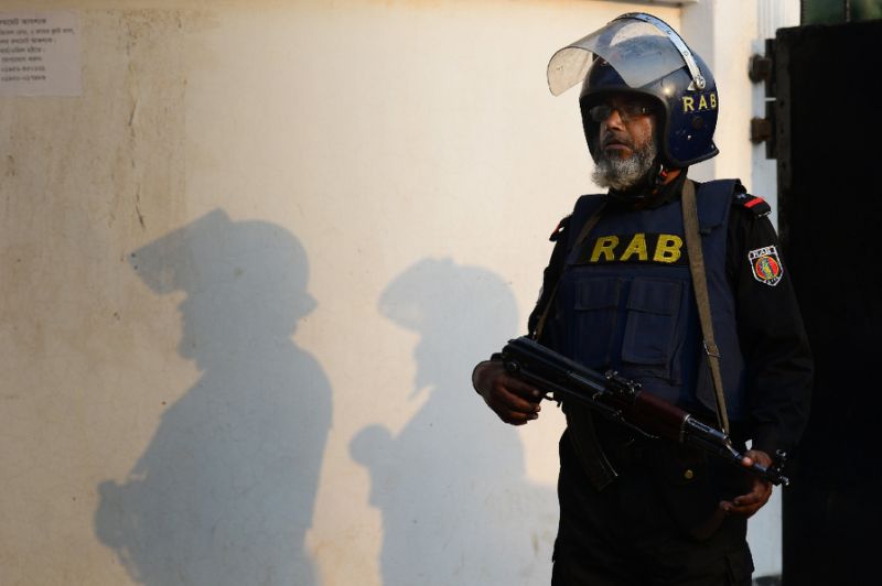 bangladesh rapid action battalion rab personnel stand alert at the entrance to a military camp in dhaka on march 17 2017 after an attempted suicide bomb attack photo afp